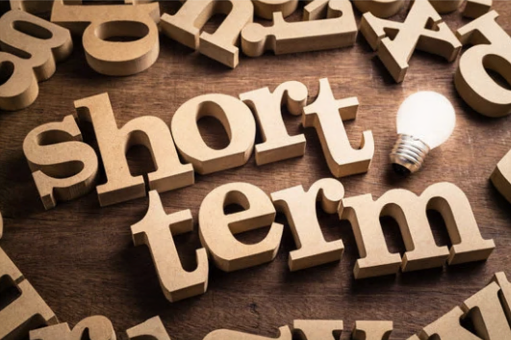 short term written in wooden letters with a light bulb